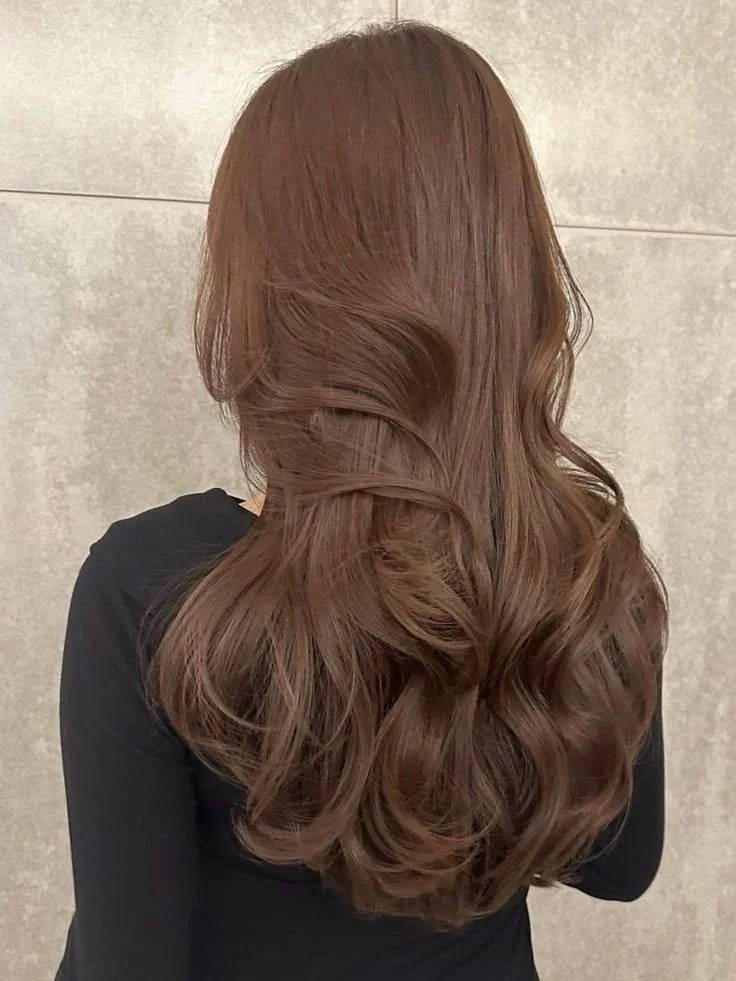 Back view of long chestnut-brown hair with loose waves